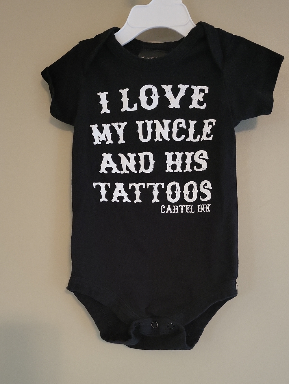 "I love my uncle and his tattoos" black onesie/bodysuit